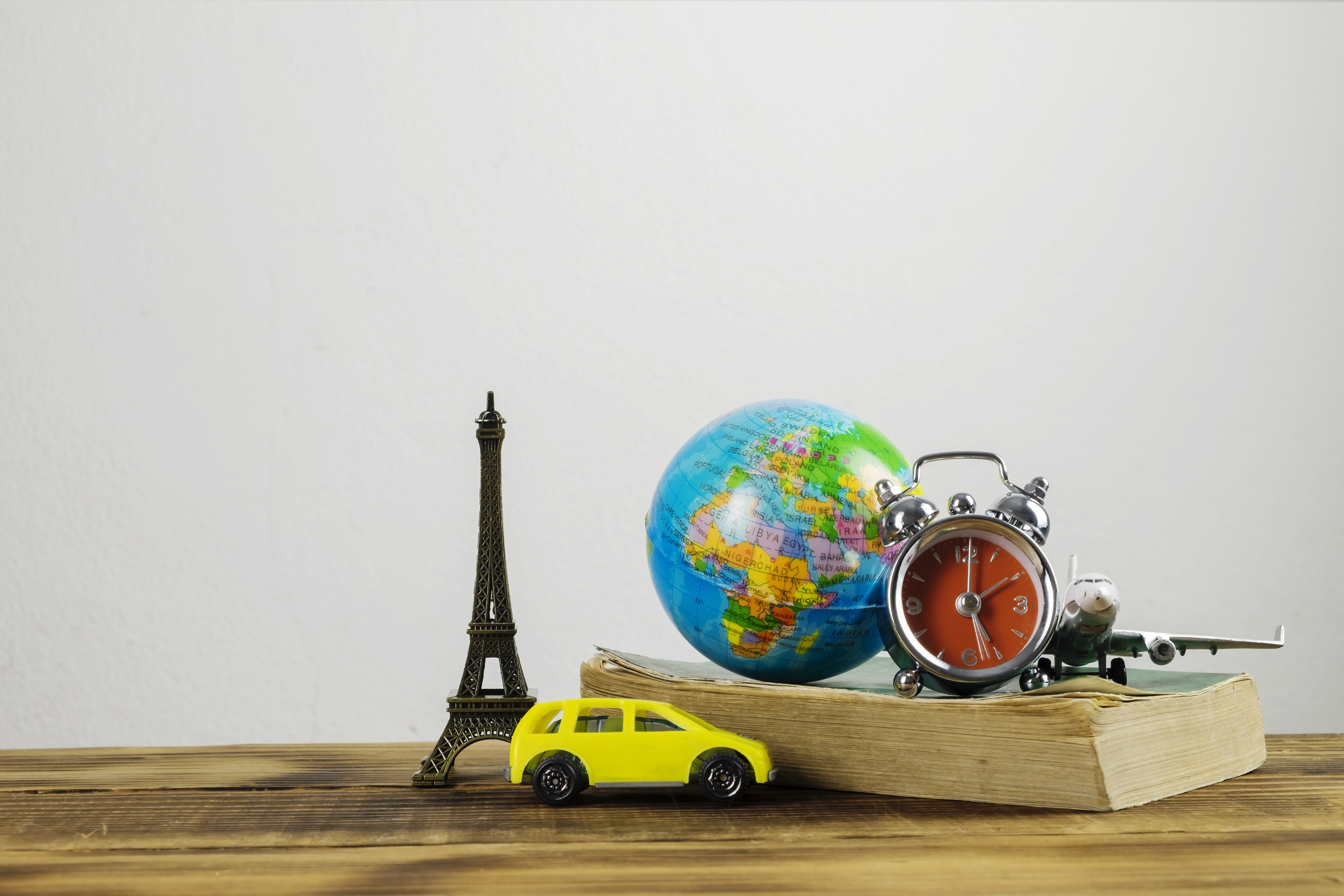 Travel-related models of an atlas, aeroplane and the Eiffel Tower