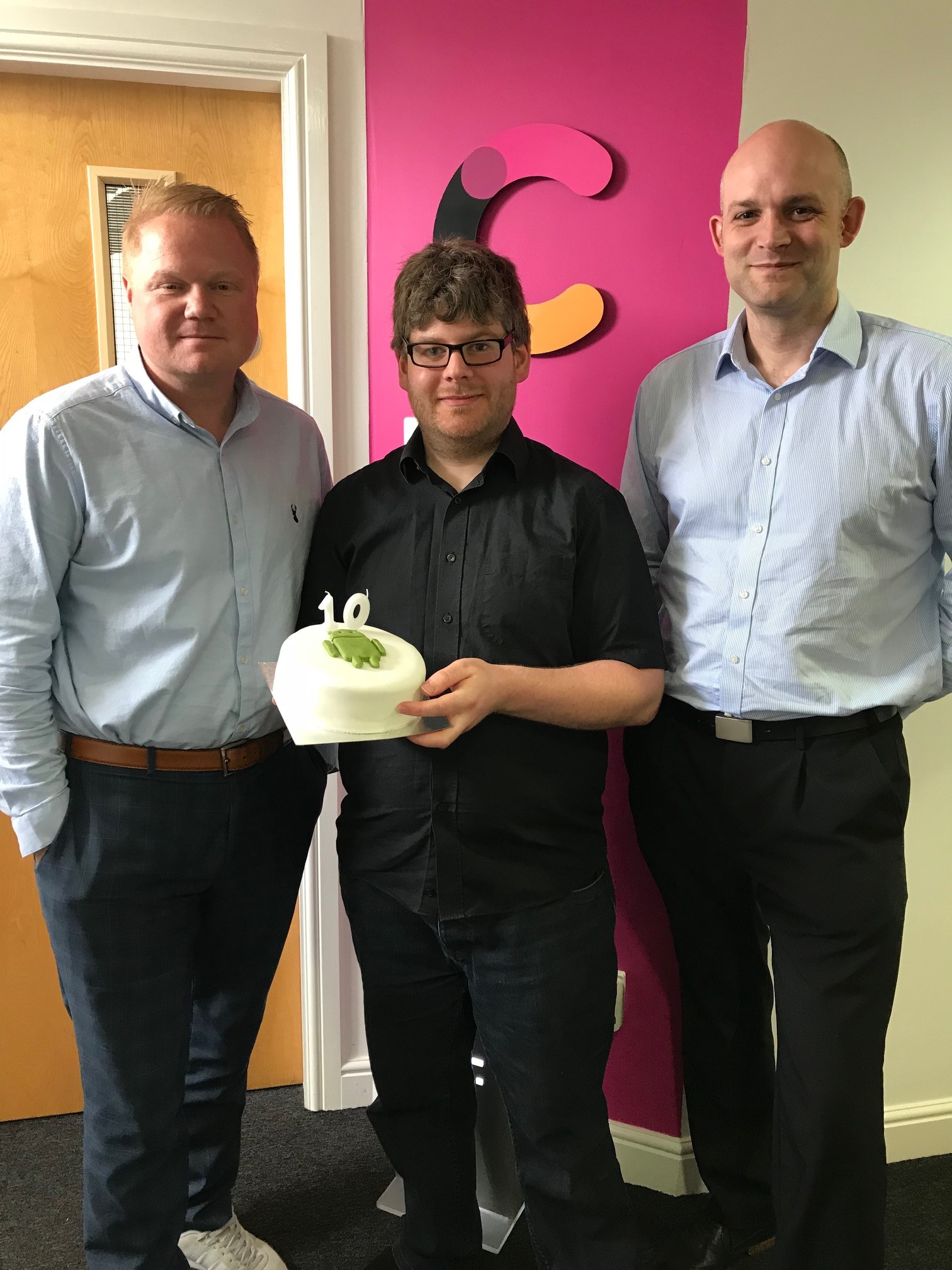 Andy celebrating with a cake for his 10-year anniversary at CSI Media with senior management