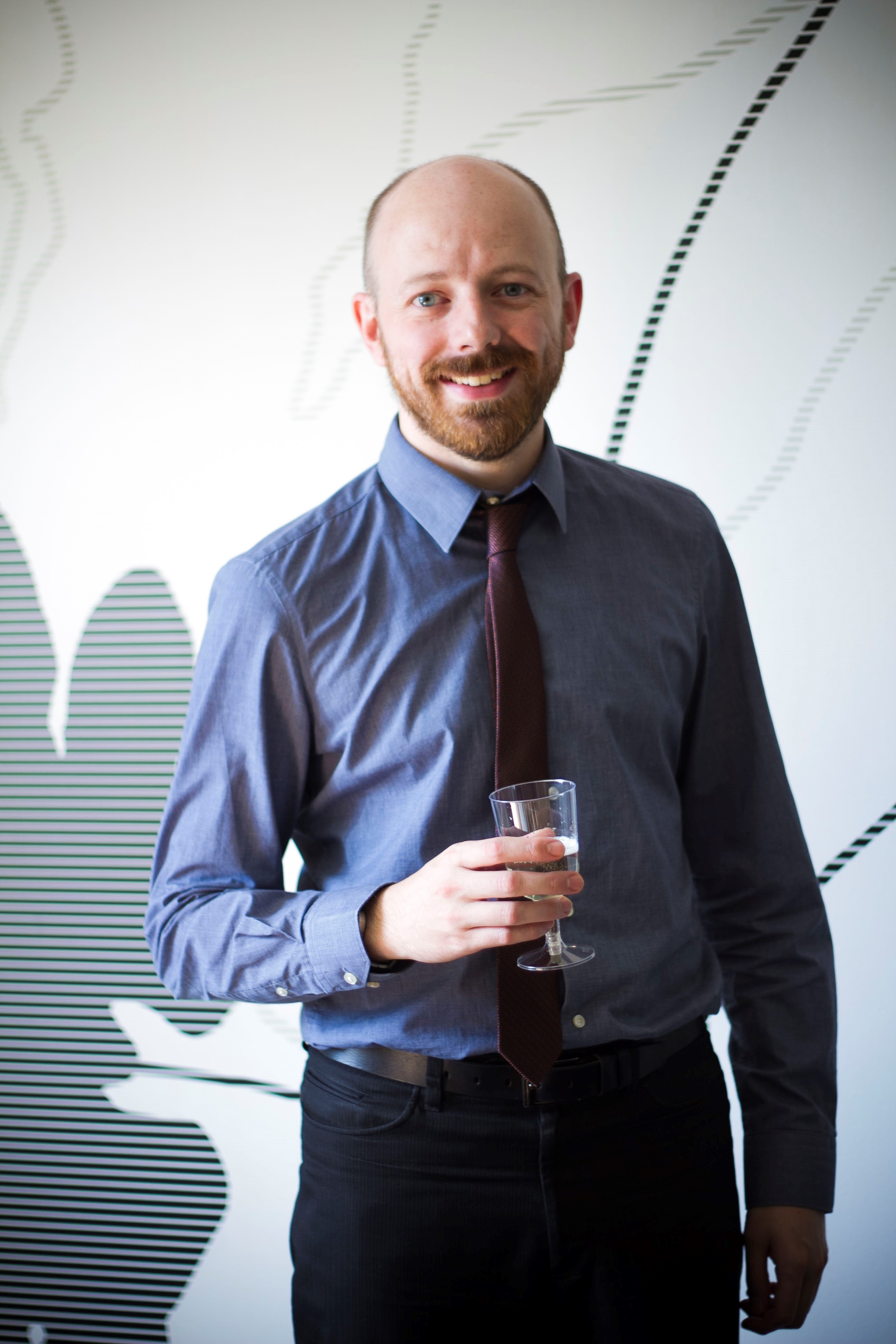 Nick Celebrating 10 Years at CSI Media with a Glass of Champagne