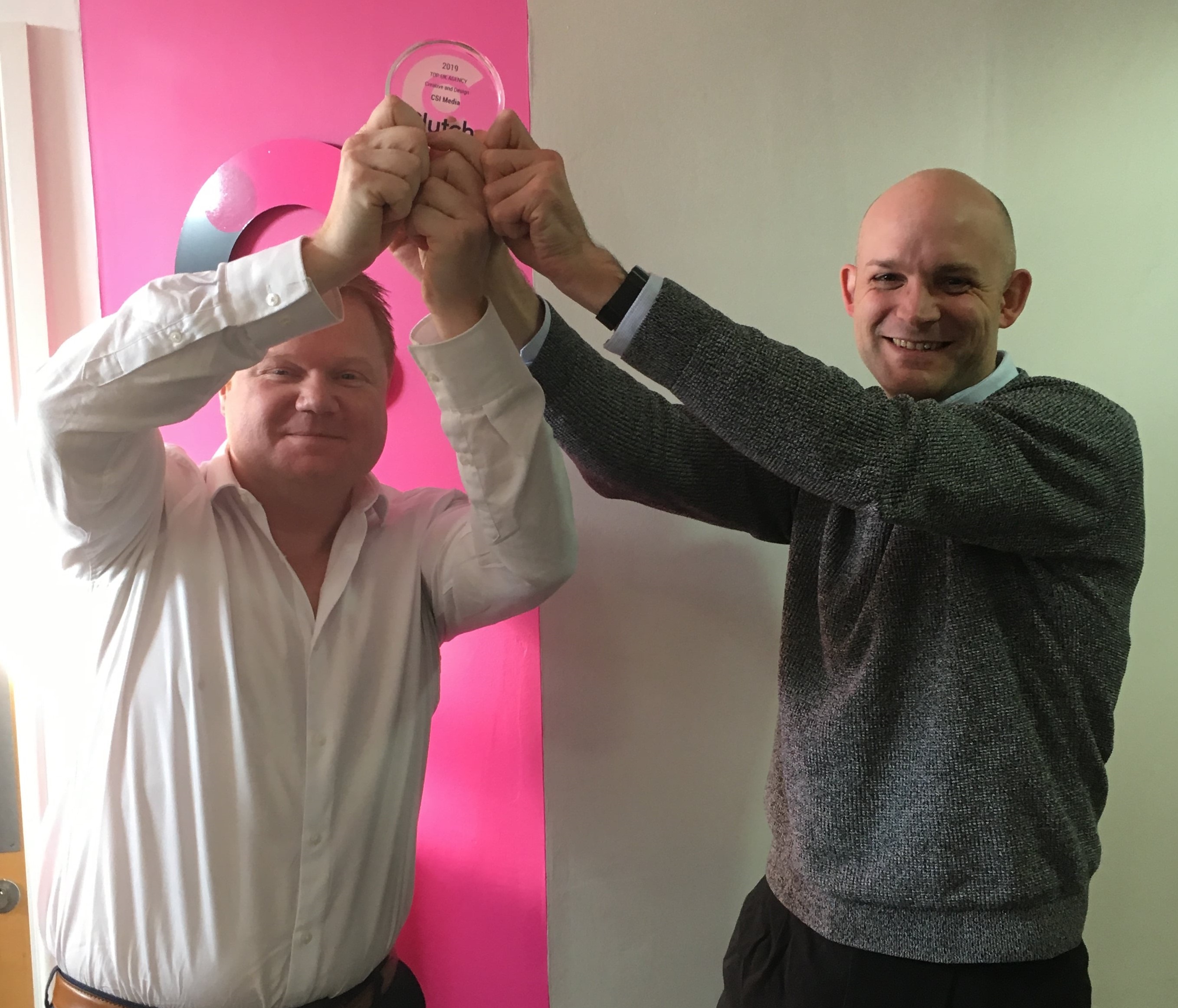 Richard and John Holding a the Clutch trophy for Leading Creative and Design Agency